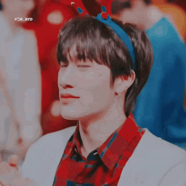 a boy wearing a headband with reindeer antlers on it
