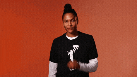 a woman wearing a nike t-shirt with a basketball player on it