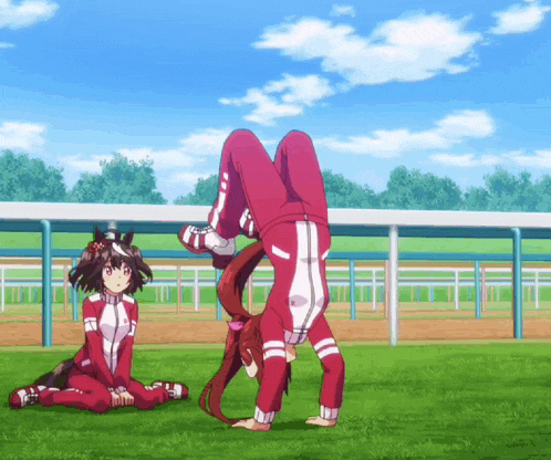 a person doing a handstand while another person sits behind them