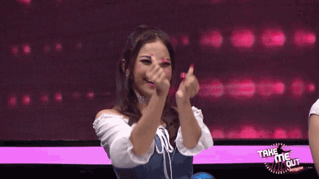 a woman stands in front of a take me out sign