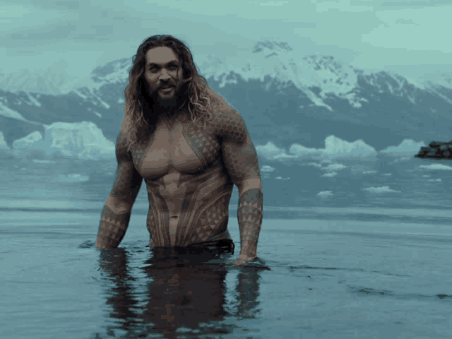 a man with a beard is standing in a body of water