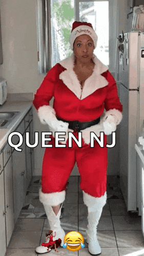 a woman in a santa suit is standing in a kitchen with queen nj written on the bottom