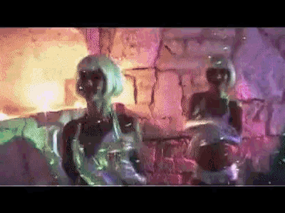 a group of women are dancing in front of a wall