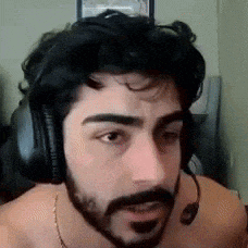 a shirtless man with a beard is wearing headphones .