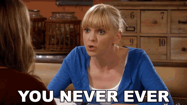 a woman in a blue sweater is sitting at a table and says " you never ever "