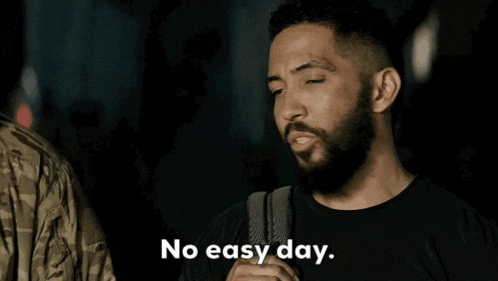 a man with a beard and a backpack says no easy day