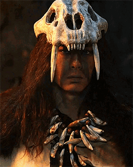 a man is wearing a skull mask with teeth