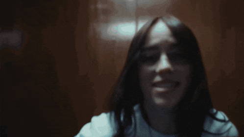 a blurry picture of a man 's face in a dark room with lights behind him