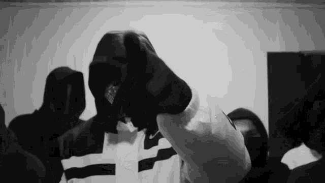 a black and white photo of a man wearing a white glove