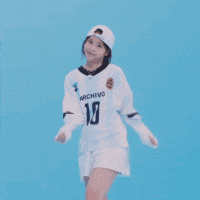 a woman wearing a white shirt with the number 10 on it is dancing