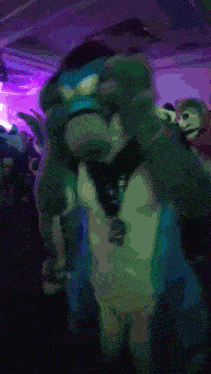 a blurred image of a person in a furry costume with a lanyard that says ' a ' on it