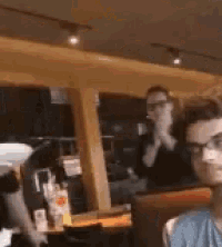 a group of people are sitting in a restaurant .