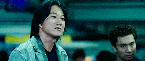 a man in a grey jacket stands next to another man