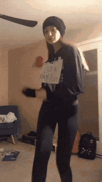a woman is holding a sign that says born angels