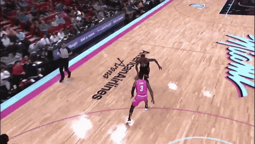 a basketball player with the number 3 on his jersey dribbles the ball