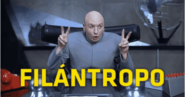 a bald man is giving a peace sign in front of the word filanthropo