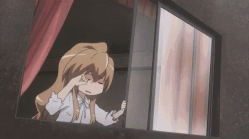 a girl is looking out of a window with her hand on her face