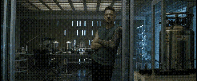 a man with a tattoo on his arm is standing in a room with the words i 'll do it above him
