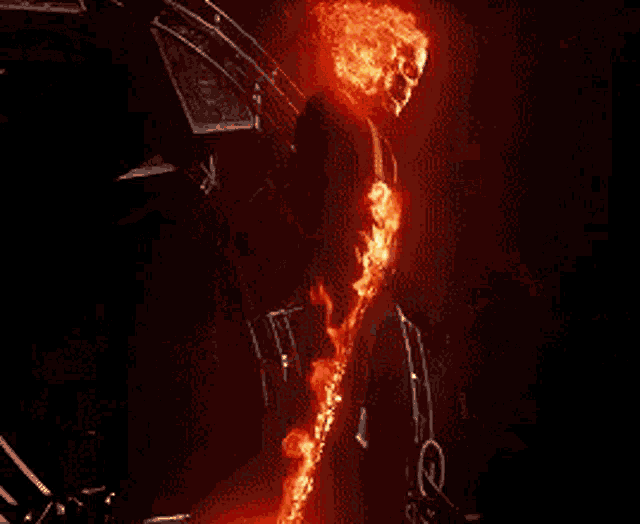 a person is riding a ghost rider motorcycle with a flame coming out of his mouth .