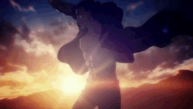 a man with his arms outstretched is standing in front of a sunset in a desert .