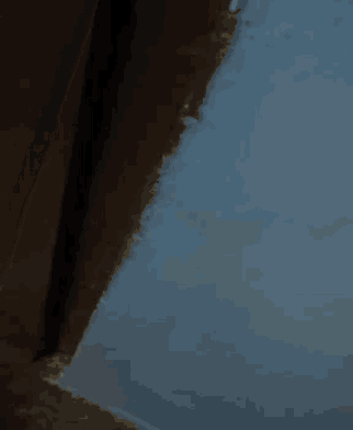 a close up of a corner of a wall with a brick wall in the background .