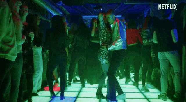 a man and a woman are dancing on a dance floor with a netflix logo behind them