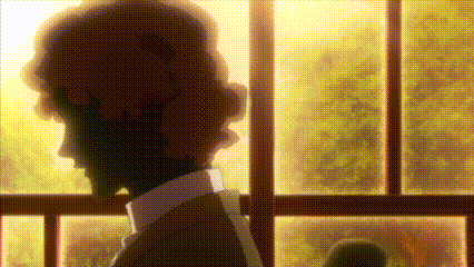 a man is standing in front of a window and looking out .