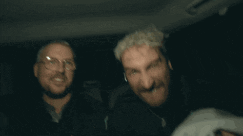 a man with white hair and a beard is smiling and says schillo