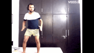 a man wearing headphones is dancing on a bed with the word veed.i on the bottom