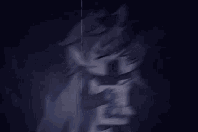 a cartoon character is holding a card in a dark room .