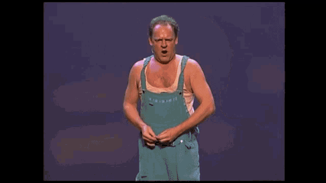 a man in a blue tank top with the word ho eem on his chest