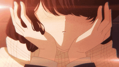 a close up of a girl covering her ears with her hands