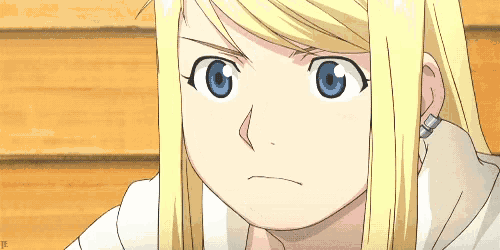 a girl with blonde hair and blue eyes is looking at the camera