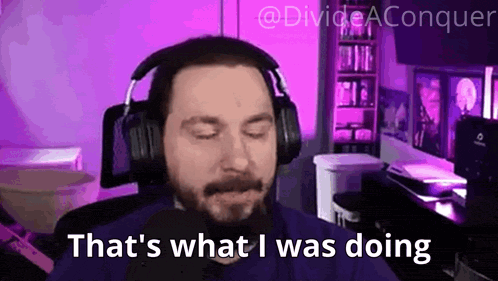 a man wearing headphones is saying that 's what i was doing while sitting in front of a computer .