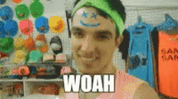 a man with a smiley face painted on his forehead and the word woah on his chest