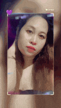 a woman 's face is displayed in a frame with the number 3762 above her
