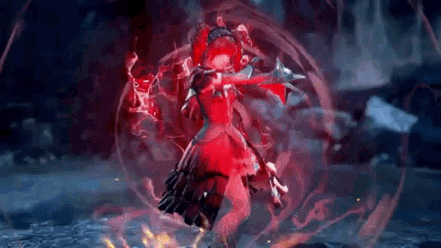 a girl in a red dress is standing in a dark room surrounded by fire .