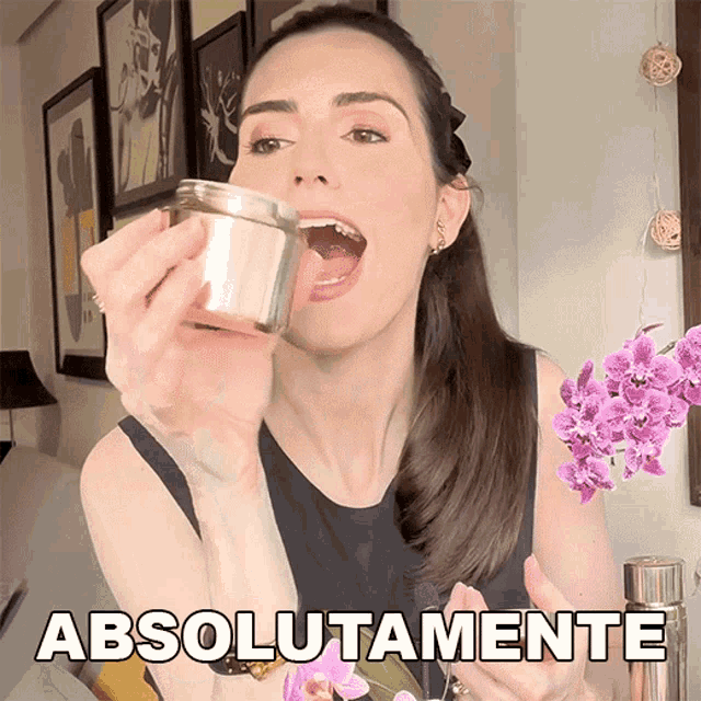 a woman is holding a jar with her mouth open and the word absolutamente is above her head