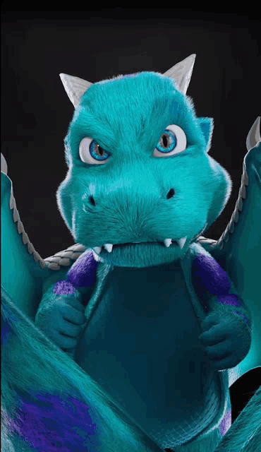 a blue and purple stuffed dragon with wings looks at the camera