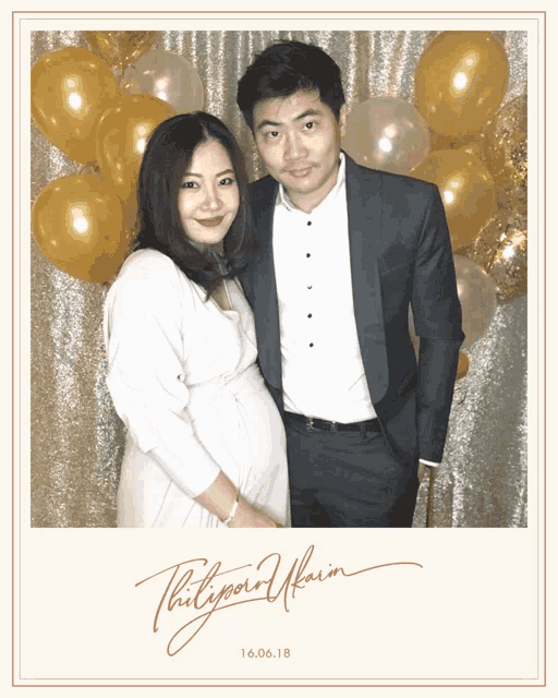 a man and a pregnant woman pose for a picture with the date 16.06.18