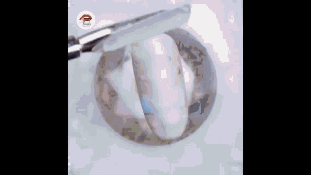 a close up of a nail being painted with a brush and the word nails in the corner