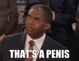 a man in a suit and tie is making a funny face and says `` that 's a penis '' .