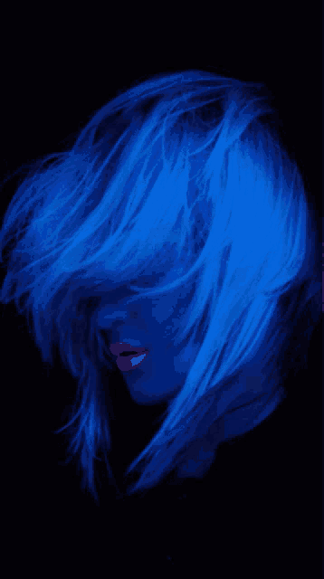 a woman with glow in the dark hair and pink lips