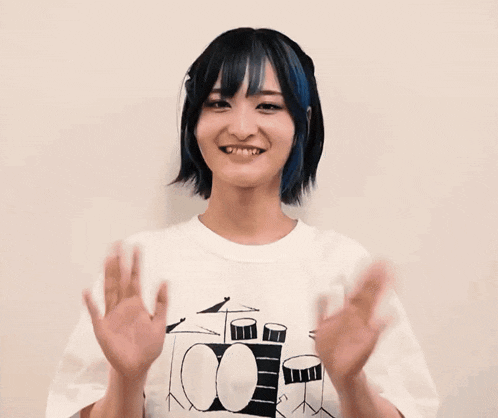 a woman wearing a t-shirt with drums on it