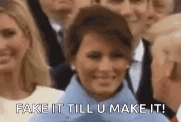 a group of people are standing around a woman who is smiling and says `` fake it till u make it '' .