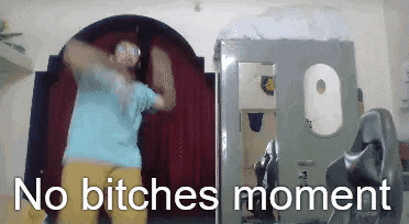 a man is dancing in a room with the words " no bitches moment " behind him