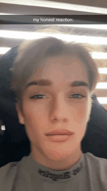a young man taking a selfie with a caption that says " my honest reaction "