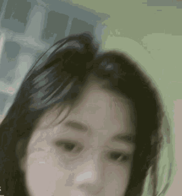 a close up of a girl 's face with a green background