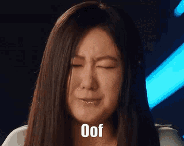 a woman with her eyes closed is crying with the word oof on her face