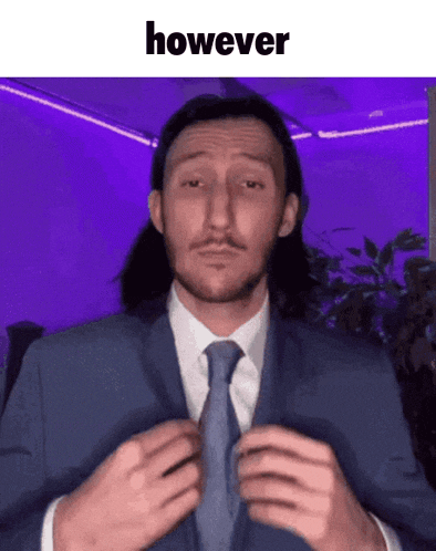 a man in a suit and tie is adjusting his tie and says however
